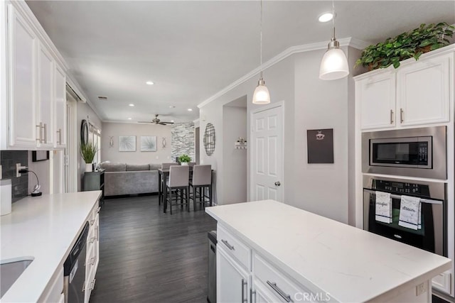 893 Whimbrel Way, Perris, CA 92571 - kitchen with appliances with stainless steel finishes, white cabinets, ornamental molding, a ceiling fan, and open floor plan