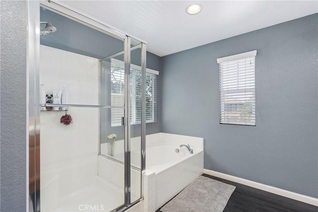 893 Whimbrel Way, Perris, CA 92571 - bathroom with a shower stall, a bath, baseboards, and wood finished floors