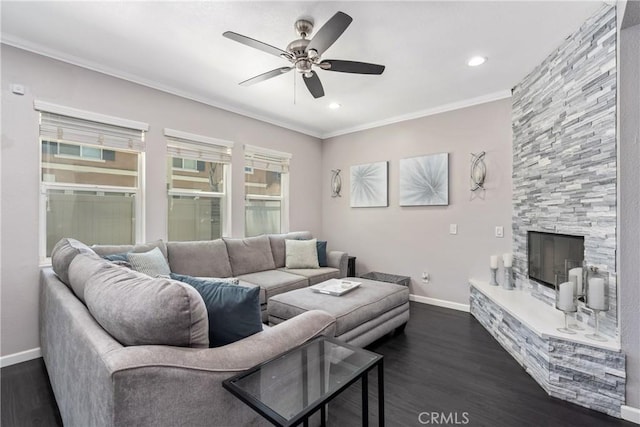 893 Whimbrel Way, Perris, CA 92571 - living area with baseboards, a ceiling fan, dark wood-style flooring, a stone fireplace, and crown molding