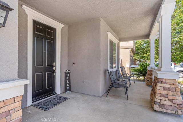 893 Whimbrel Way, Perris, CA 92571 - doorway to property featuring covered porch and stucco siding