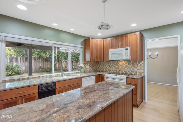 433 Havenside Ave, Newbury Park, CA 91320 - kitchen featuring white appliances, a sink, brown cabinetry, decorative backsplash, and light stone countertops