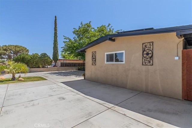 38868 Yucca Tree St, Palmdale, CA 93551 - view of home's exterior with a patio area and stucco siding