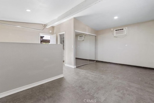 38868 Yucca Tree St, Palmdale, CA 93551 - spare room with a wall mounted AC, concrete flooring, recessed lighting, baseboards, and beam ceiling
