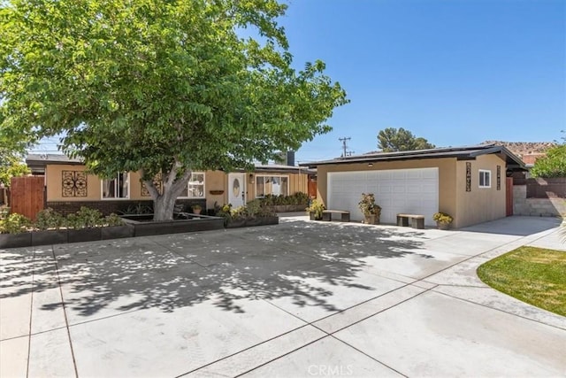 38868 Yucca Tree St, Palmdale, CA 93551 - view of front of house featuring roof mounted solar panels, stucco siding, driveway, and an attached garage
