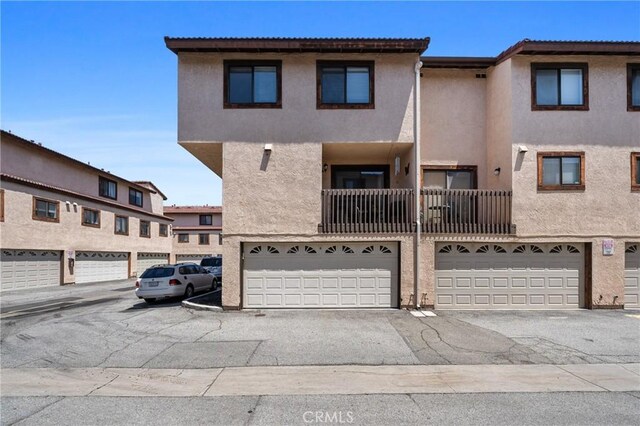 20815 Norwalk Blvd Unit 6, Lakewood, CA 90715 - view of front facade with stucco siding and an attached garage