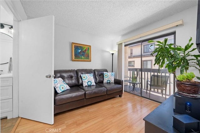 20815 Norwalk Blvd Unit 6, Lakewood, CA 90715 - living room with a textured ceiling and light wood-style flooring
