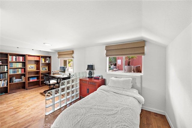 28751 Top Of The World Dr, Laguna Beach, CA 92651 - bedroom featuring multiple windows, wood finished floors, vaulted ceiling, baseboards, and an office area