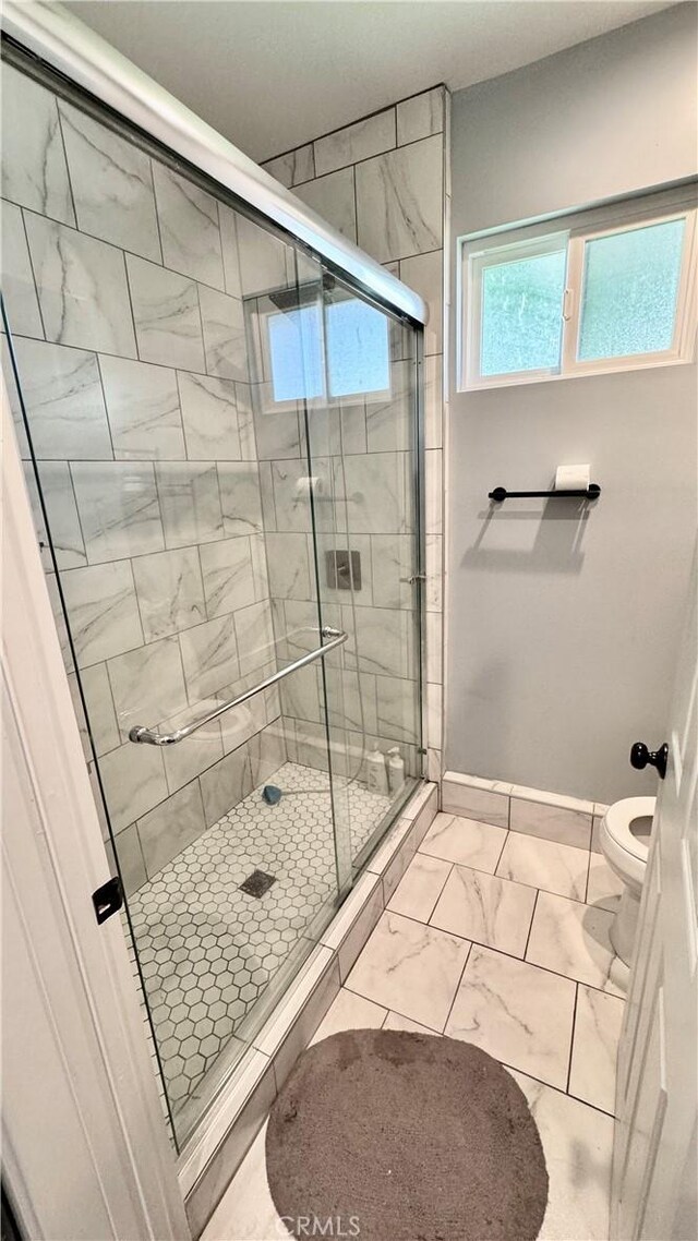 6916 Claire Ave, Reseda, CA 91335 - full bath with toilet, a shower stall, marble look tile flooring, and baseboards