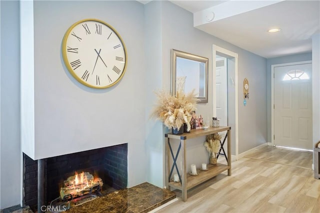 6916 Claire Ave, Reseda, CA 91335 - foyer featuring light wood finished floors, baseboards, a warm lit fireplace, and recessed lighting