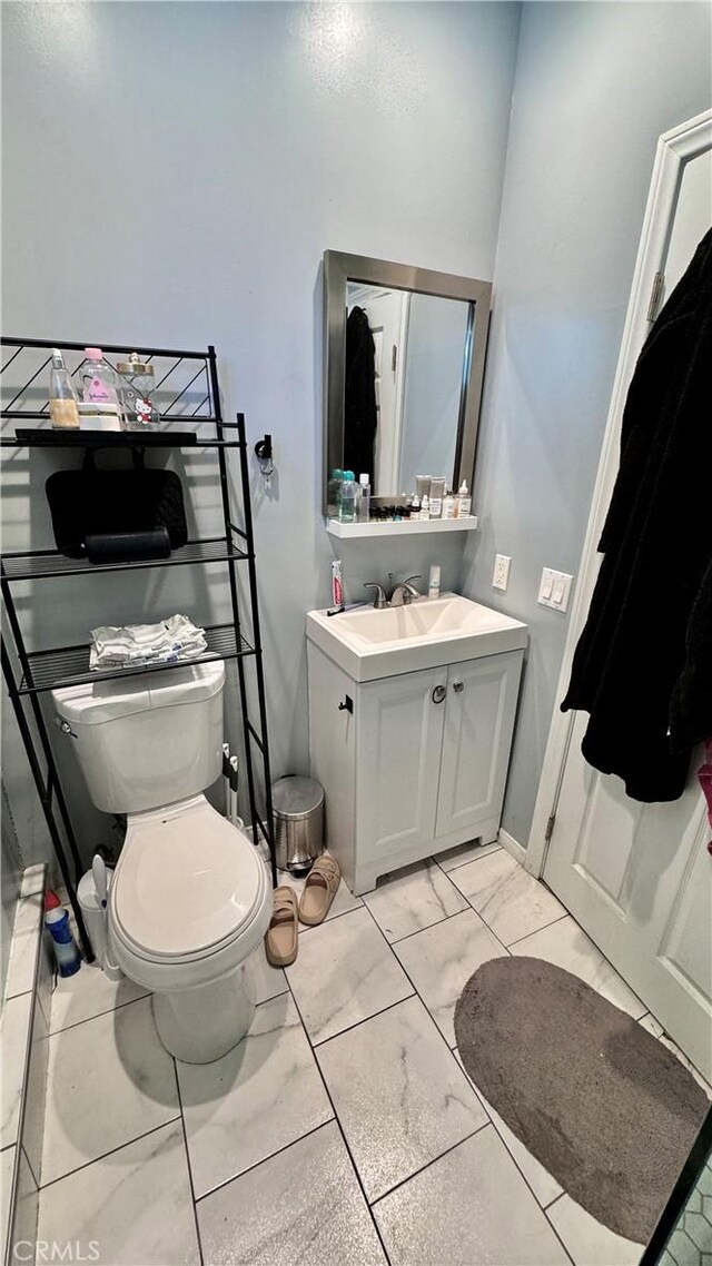6916 Claire Ave, Reseda, CA 91335 - bathroom featuring vanity, toilet, and marble look tiles