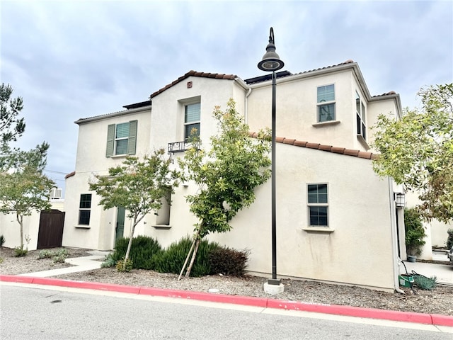 299 E Arrow Hwy Unit 4, Glendora, CA 91740 - view of front of property with stucco siding and a tiled roof