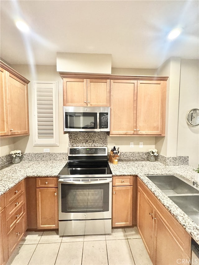 299 E Arrow Hwy Unit 4, Glendora, CA 91740 - kitchen with appliances with stainless steel finishes, a sink, light tile patterned flooring, and light stone counters