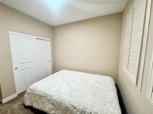 299 E Arrow Hwy Unit 4, Glendora, CA 91740 - bedroom featuring dark colored carpet, baseboards, and a closet
