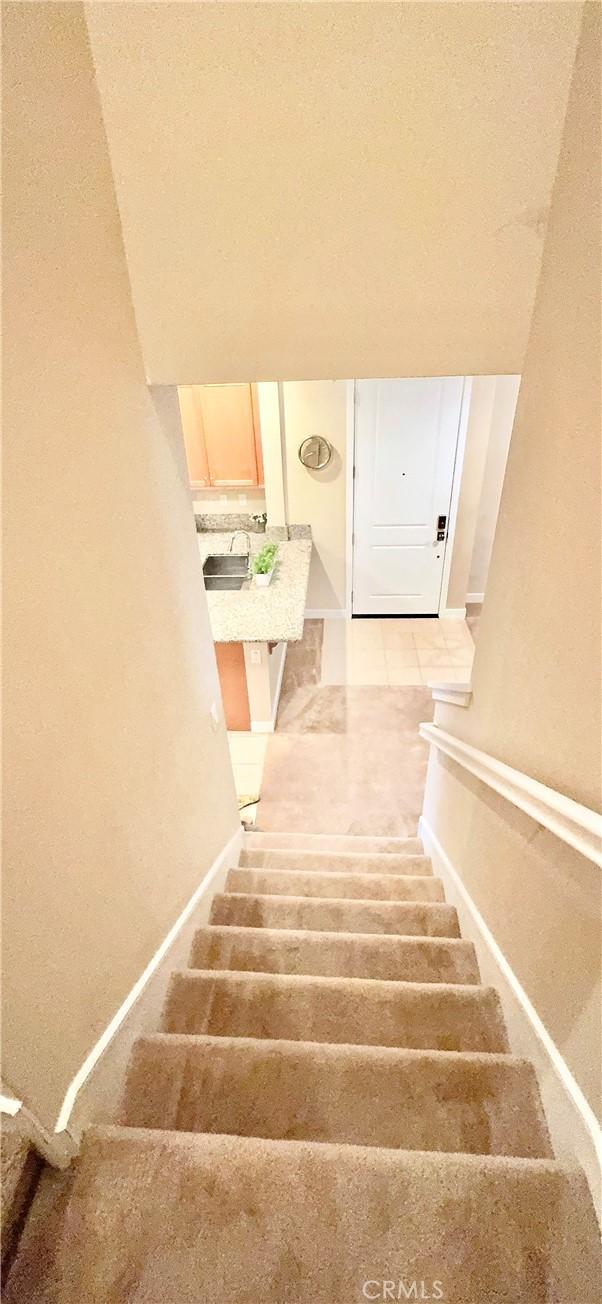 299 E Arrow Hwy Unit 4, Glendora, CA 91740 - staircase with baseboards