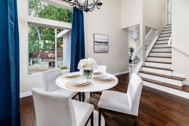 3362 Edgeview, San Marcos, CA 92078 - dining room with a chandelier, stairs, baseboards, wood finished floors, and a towering ceiling