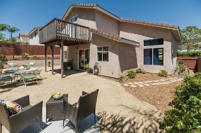 3362 Edgeview, San Marcos, CA 92078 - rear view of house featuring a wooden deck, a fenced backyard, stucco siding, a patio, and outdoor dining area