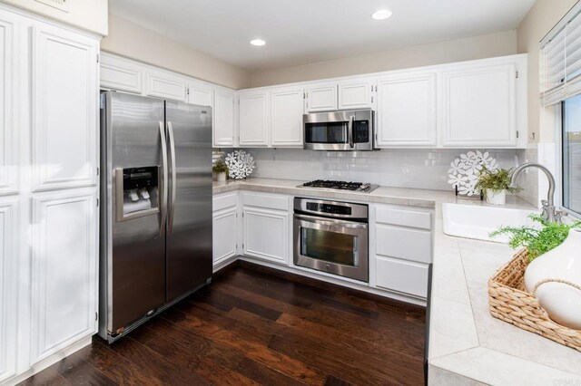 3362 Edgeview, San Marcos, CA 92078 - kitchen featuring appliances with stainless steel finishes, a sink, light countertops, white cabinets, and backsplash