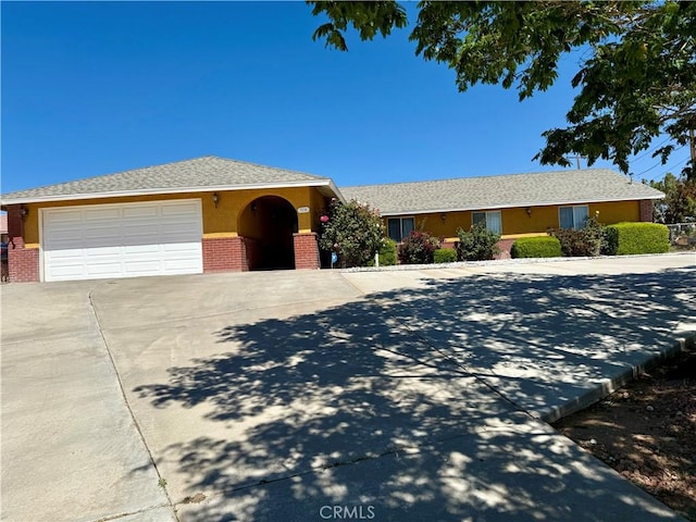 7218 Dalscote St, Hesperia, CA 92345 - single story home with driveway, brick siding, a garage, and stucco siding