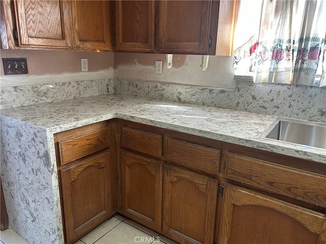 7218 Dalscote St, Hesperia, CA 92345 - kitchen with brown cabinets and light tile patterned floors