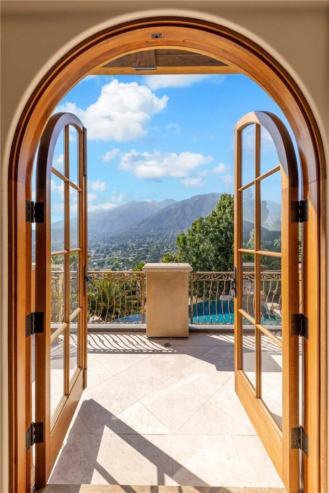 367 Monterey Pines Dr, Arcadia, CA 91006 - doorway to outside with a mountain view, french doors, arched walkways, and tile patterned flooring