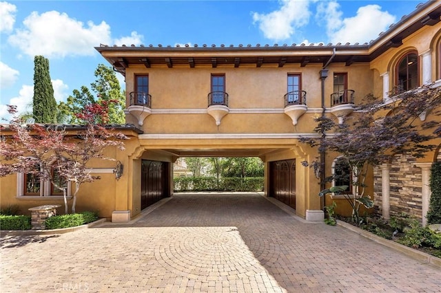 367 Monterey Pines Dr, Arcadia, CA 91006 - mediterranean / spanish home with a balcony, stucco siding, and decorative driveway
