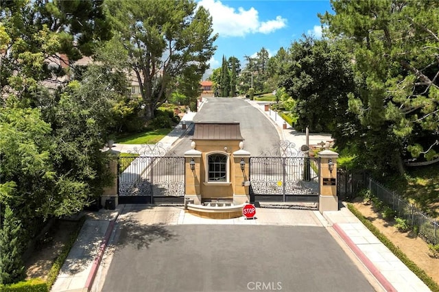 367 Monterey Pines Dr, Arcadia, CA 91006 - view of front of house with a gate, stucco siding, and view of scattered trees