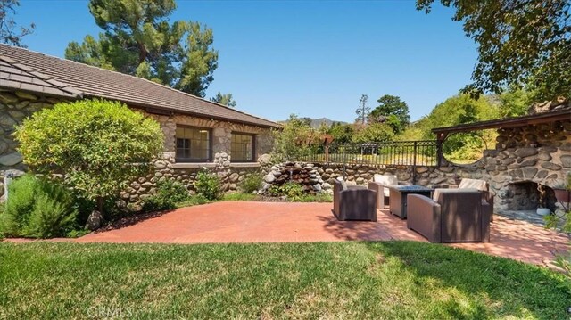 2304 Rosedale Curv, Upland, CA 91784 - view of yard with a patio and an outdoor living space with a fireplace