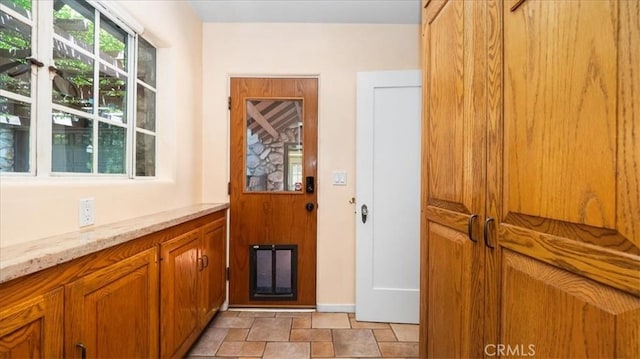 2304 Rosedale Curv, Upland, CA 91784 - doorway to outside featuring stone finish flooring and baseboards