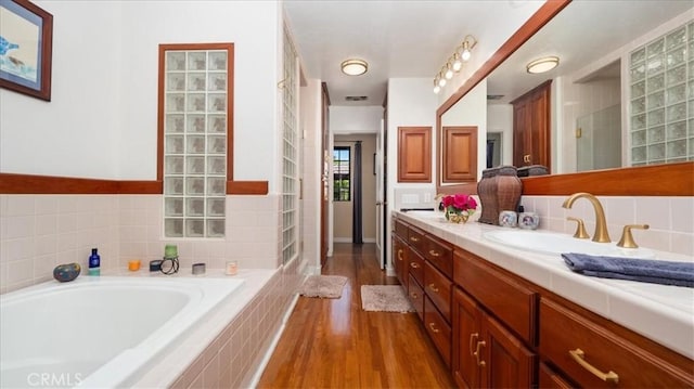2304 Rosedale Curv, Upland, CA 91784 - full bath with vanity, a bath, wood finished floors, and a tile shower