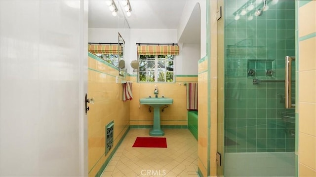 2304 Rosedale Curv, Upland, CA 91784 - bathroom with tile patterned flooring, tile walls, and a stall shower