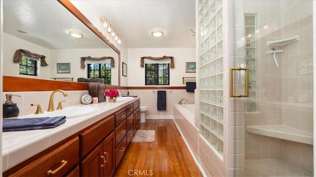 2304 Rosedale Curv, Upland, CA 91784 - full bathroom with wood finished floors, a shower stall, double vanity, a bath, and tile walls