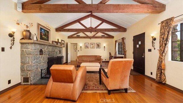 2304 Rosedale Curv, Upland, CA 91784 - living area with wood finished floors, a stone fireplace, and baseboards