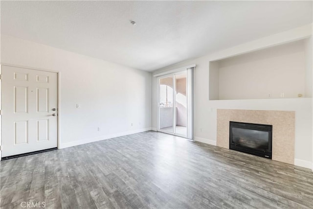 41410 Juniper St Unit 2622, Murrieta, CA 92562 - unfurnished living room with wood finished floors, a fireplace, and baseboards