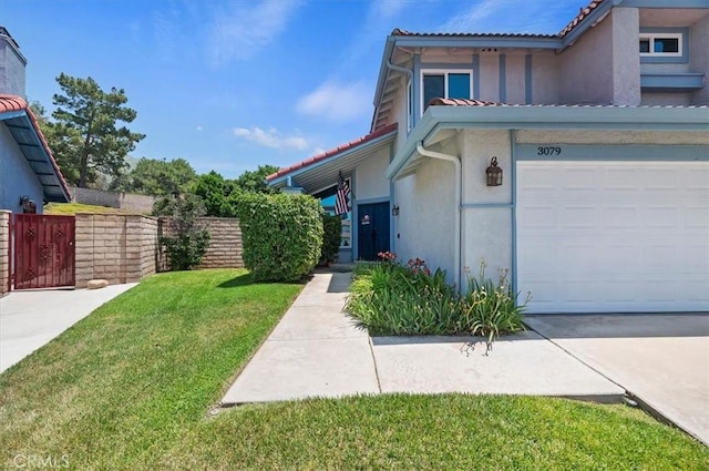 3079 Mojave Ct, Highland, CA 92346 - view of property exterior featuring stucco siding, an attached garage, and a tiled roof