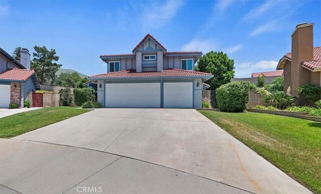 3079 Mojave Ct, Highland, CA 92346 - mediterranean / spanish home featuring a tiled roof, driveway, stucco siding, and an attached garage