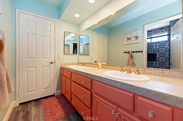 3079 Mojave Ct, Highland, CA 92346 - bathroom featuring wood finished floors, double vanity, baseboards, recessed lighting, and a shower