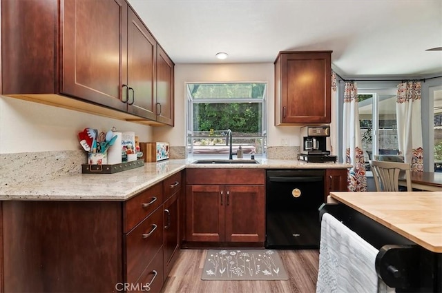 3079 Mojave Ct, Highland, CA 92346 - kitchen with black dishwasher, a sink, light wood-style floors, and light stone counters