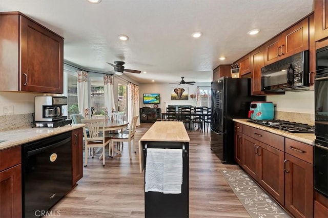 3079 Mojave Ct, Highland, CA 92346 - kitchen with black appliances, a ceiling fan, recessed lighting, light wood-style flooring, and light stone countertops
