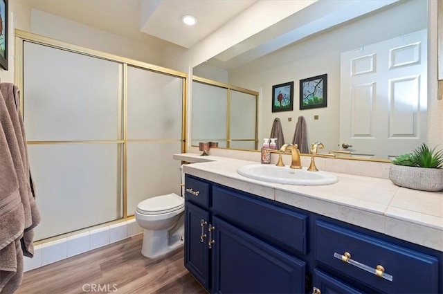 3079 Mojave Ct, Highland, CA 92346 - bathroom with toilet, vanity, a stall shower, and wood finished floors