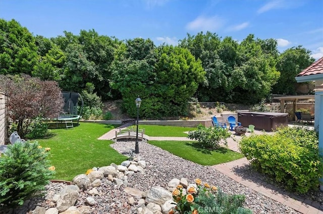 3079 Mojave Ct, Highland, CA 92346 - view of yard with a trampoline, a hot tub, and a patio area