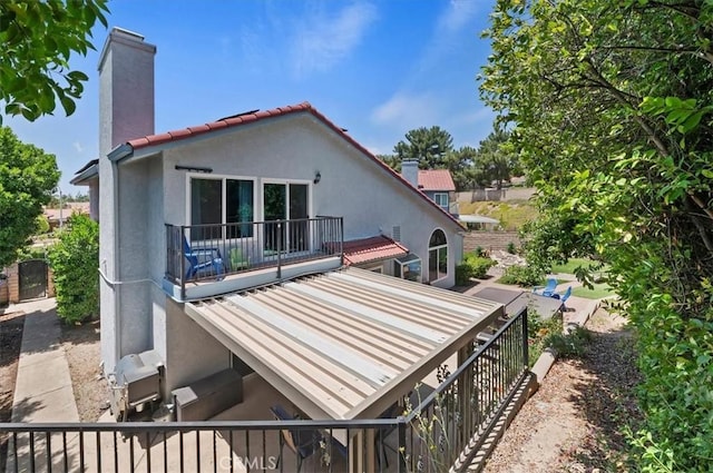 3079 Mojave Ct, Highland, CA 92346 - back of property featuring a chimney and stucco siding