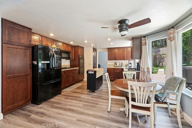 3079 Mojave Ct, Highland, CA 92346 - kitchen featuring black appliances, light wood-style flooring, ceiling fan, recessed lighting, and a center island