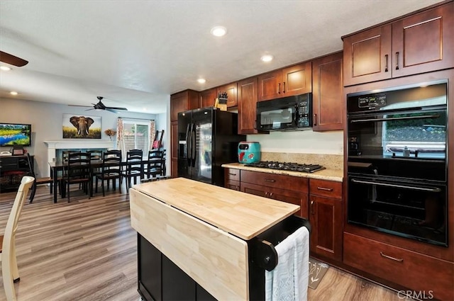 3079 Mojave Ct, Highland, CA 92346 - kitchen with black appliances, ceiling fan, light wood-type flooring, wood counters, and recessed lighting