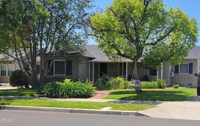 view of front of property with a front lawn and a shingled roof
