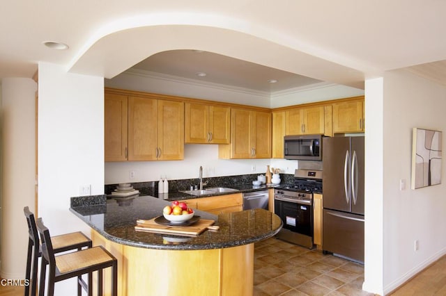 12603 Moorpark St Unit 303, Studio City, CA 91604 - kitchen featuring appliances with stainless steel finishes, a sink, a peninsula, dark stone counters, and crown molding