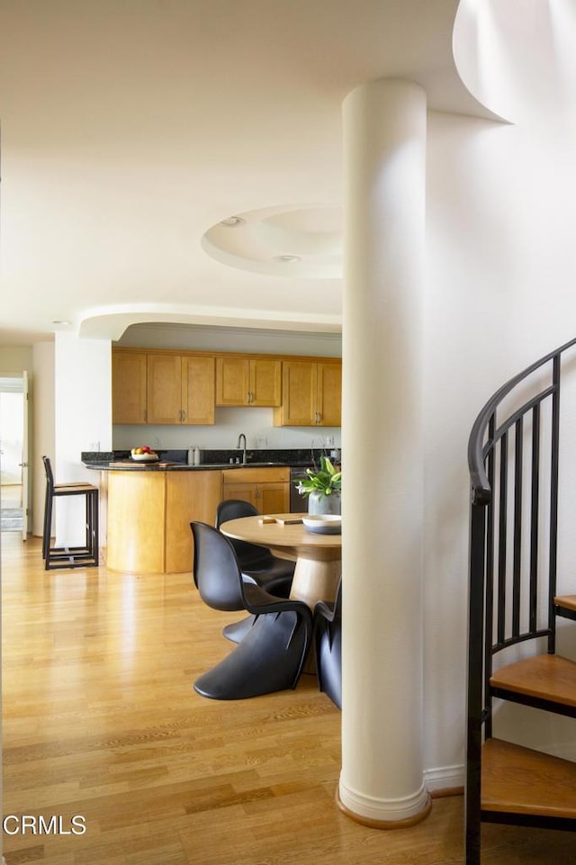 12603 Moorpark St Unit 303, Studio City, CA 91604 - kitchen with dark countertops, light wood-style floors, and a sink