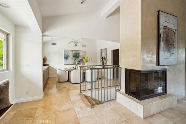 3336 Villa Mesa Rd, Pasadena, CA 91107 - foyer entrance featuring lofted ceiling, baseboards, a tile fireplace, and light tile patterned flooring