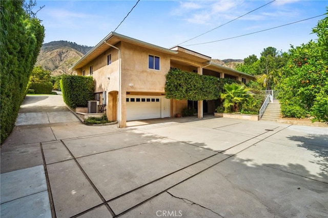 3336 Villa Mesa Rd, Pasadena, CA 91107 - view of front of property featuring a garage, concrete driveway, a mountain view, and stucco siding