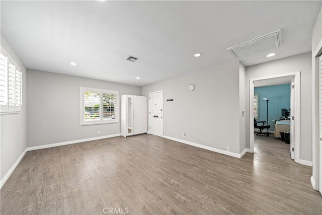 15439 Studebaker Rd, Norwalk, CA 90650 - unfurnished living room featuring attic access, wood finished floors, a desk, baseboards, and recessed lighting