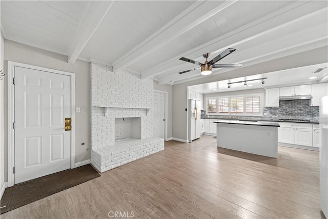 15439 Studebaker Rd, Norwalk, CA 90650 - kitchen with white fridge with ice dispenser, ceiling fan, gas stovetop, light wood finished floors, and white cabinets